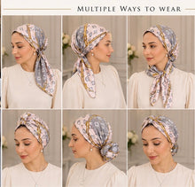 Load image into Gallery viewer, Six-panel collage showing a woman wearing the same patterned headscarf in different styles and positions, with the text 'MULTIPLE WAYS TO WEAR' at the top. The scarf has a light pink and gray monogram-style print with gold trim, and the woman wears a cream blouse against a soft neutral indoor background.