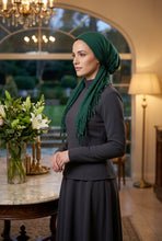 Load image into Gallery viewer, Mannequin head wearing a green headscarf with tassels on a white background