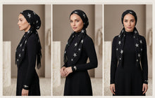 Load image into Gallery viewer, Black headscarf with star patterns on a mannequin head against a white background
