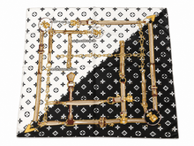 Load image into Gallery viewer, A square scarf featuring a split design of white and black with Louis Vuitton monogram patterns and a central gold chain-link frame illustration.
