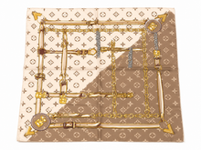 Load image into Gallery viewer, A luxury fashion scarf featuring a split design with a beige and brown Louis Vuitton monogram pattern, overlaid with a graphic of gold chains, buckles, and padlocks.
