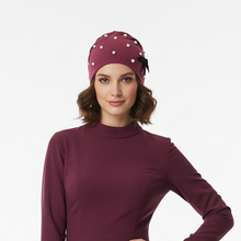 Load image into Gallery viewer, Model wearing mauve beanie with hair showing
